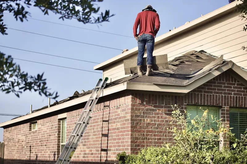 Professional roofer working on a residential roof in Cumberland